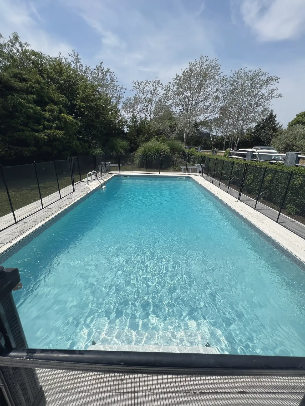 Bright turquoise pool framed by trees